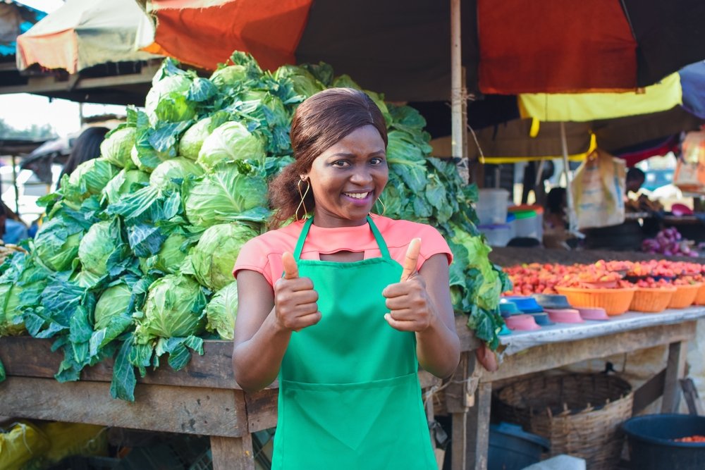 Happy,African,Business,Woman,Or,Female,Trader,Wearing,A,Green