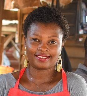 African,Woman,Or,Female,Trader,With,A,Red,Apron,,Standing